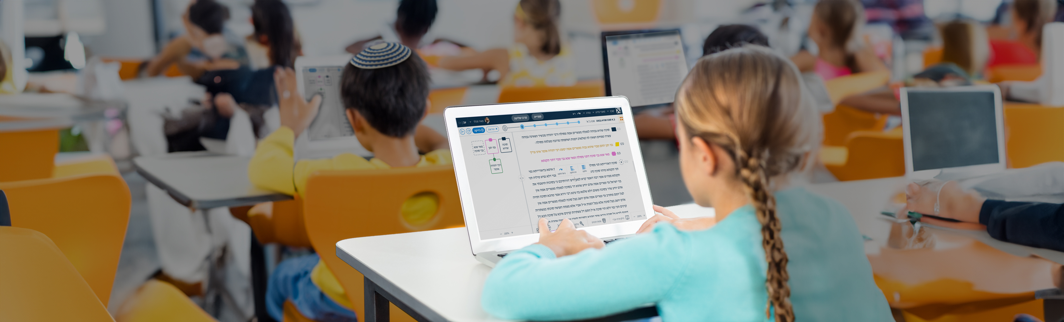 Two students in a classroom working through a Talmud passage on a tablet, with a color-coded flowchart of the argument's structure on screen.